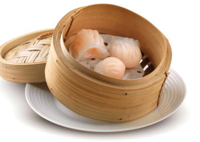 Three pieces Har Kow shrimp Dim sum in a steam basket.
