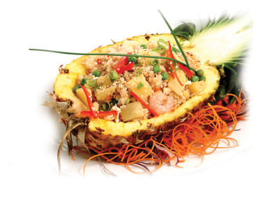 Half pineapple filled with shrimp and fried rice.