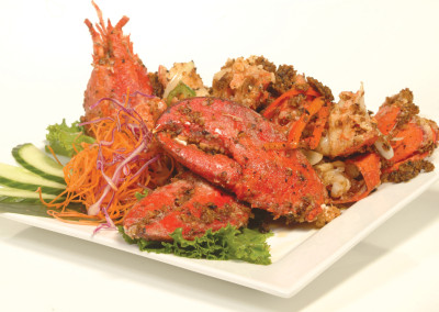 Plate of our Drunken Lobster sections with cucumber garnishes.