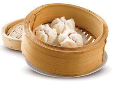 Three Cha Siu Bao served in a classic bamboo steamer.